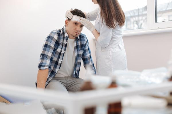 man being treated for a head injury