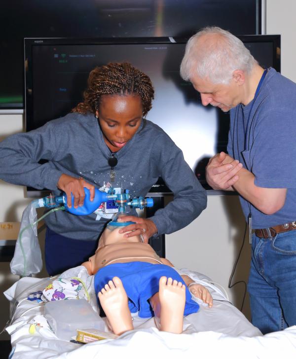 Michael Shoykhet, a pediatric intensivist and simulation champion, guides a participant in providing adequate bag valve mask ventilation to Emma Felton, a simulated pediatric patient (PediHAL S3005) with a medical history of infantile cystinosis and respiratory failure due to anaphylaxis, during the Pediatric Bridge to Practice course in February this year.