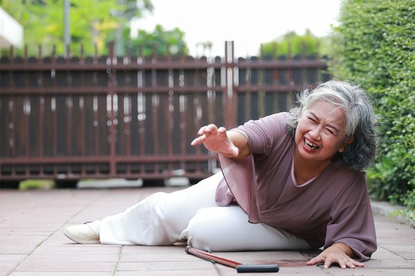 older woman on the ground in pain after a fall