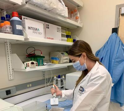 Woman in a lab wearing mask