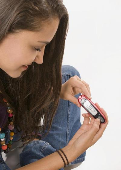 girl testing her blood sugar