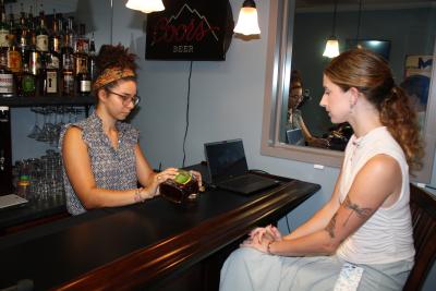 Lab members simulate experiment at replica of bar.