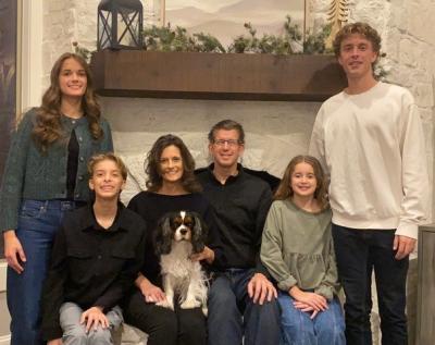 The Van Wyk family: From left, Julia, Graham, Anne, Jerry, Natalie, and Drew. The family’s dog, Kingston, is seated on Anne’s lap.